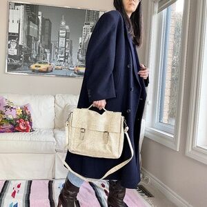 Debossed faux reptile messenger bag.